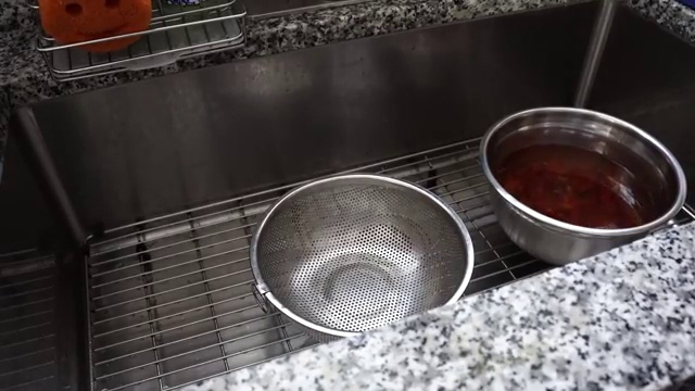 Whole cumin seeds, dried bay leaf, and cinnamon stick sizzling in hot oil