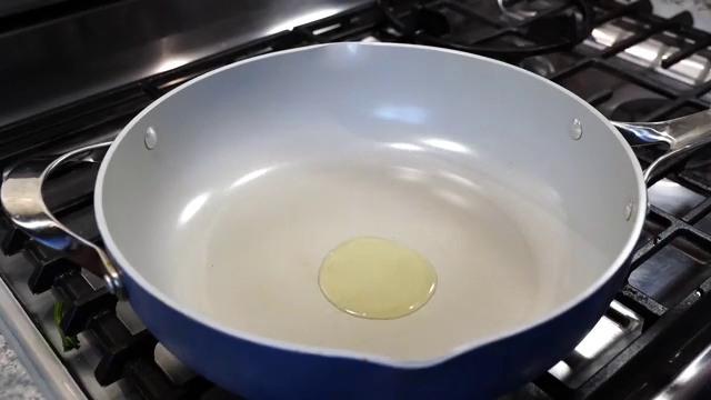 Whole cumin seeds crackling and sizzling in hot ghee and oil