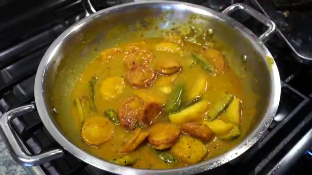 Dal boras simmering for 2 minutes in the gravy to absorb the ginger-cumin broth