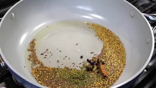 Desiccated coconut added to lightly browned onions and spices for roasting