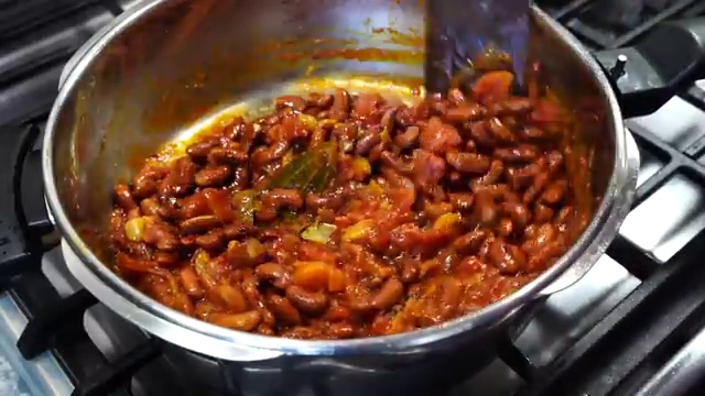 Dried red kidney beans soaking in salted water in a large bowl overnight