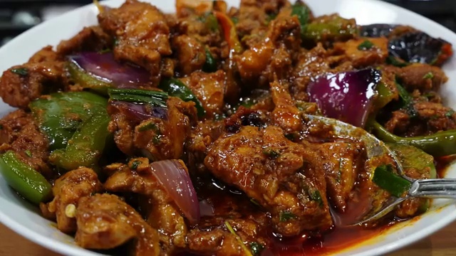 Finished Garlic Pepper Chicken plated in a bowl ready to serve with steamed rice