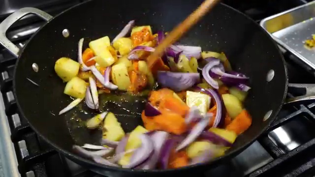 Finished tender Bengali prawns with caramelized vegetables, squash, and wilted leafy greens
