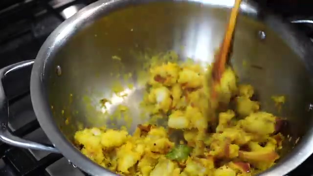 Finished Indian-style potato masala filling with turmeric, onion, curry leaves, and spices