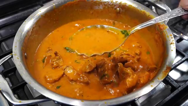 Finished Ultimate Butter Chicken displaying a glossy, rich red-orange makhani gravy