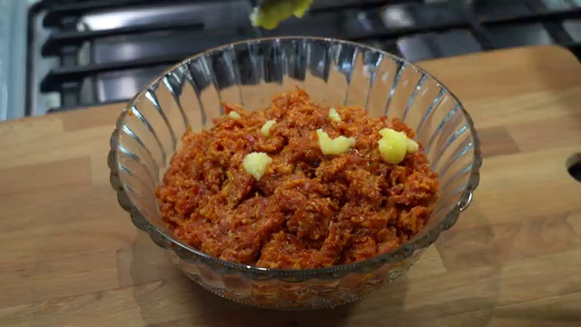Finished Indian Carrot Halwa topped with toasted almonds ready to serve
