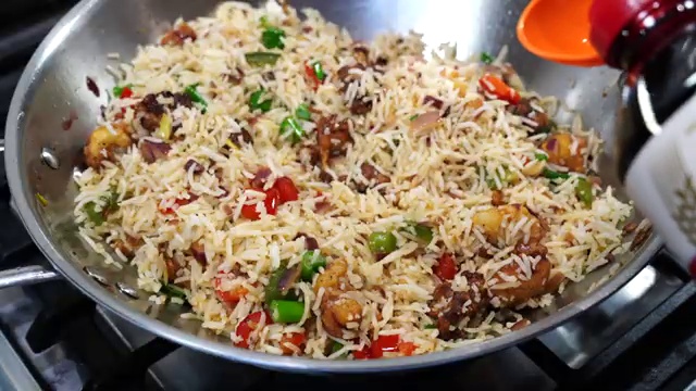 Finished Cauliflower Manchurian Fried Rice garnished with spring onions in a serving dish