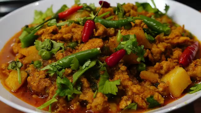 Finished Chicken Keema Curry with tender potatoes and peas garnished and ready to serve