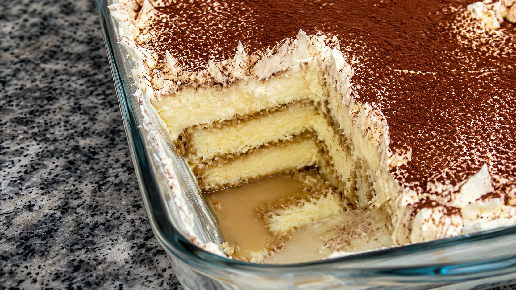Finished coffee trifle topped with cocoa powder and optional red cherries