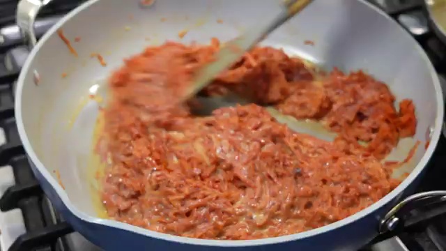 Sliced flaked almonds toasting in a dry skillet over medium-low heat