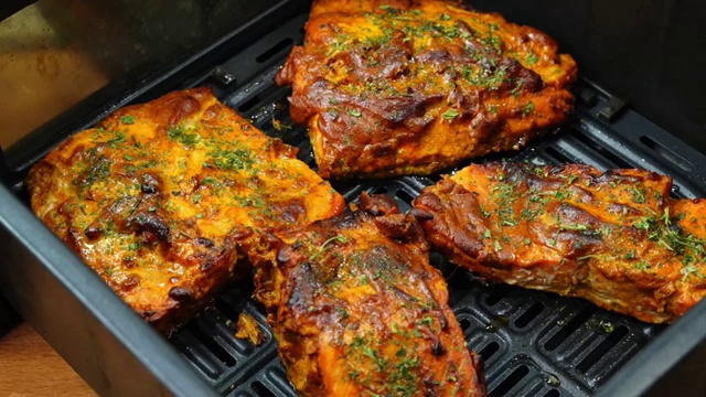 Four large fresh boneless salmon fillets arranged on a preparation board