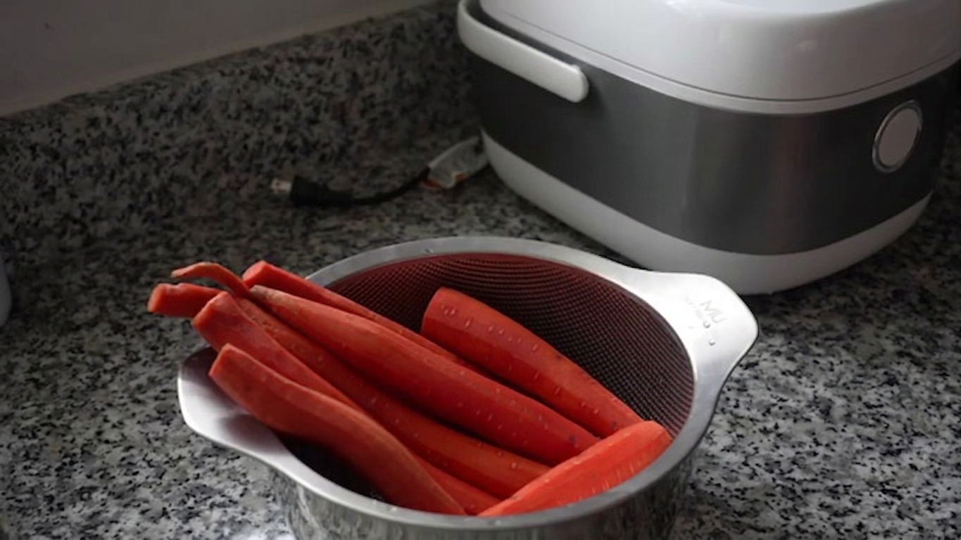 Coarsely grated fresh carrots on a preparation board ready for making Gajar Ka Halwa