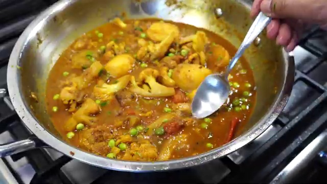 Freshly chopped coriander leaves sprinkled over the finished Bengali curry
