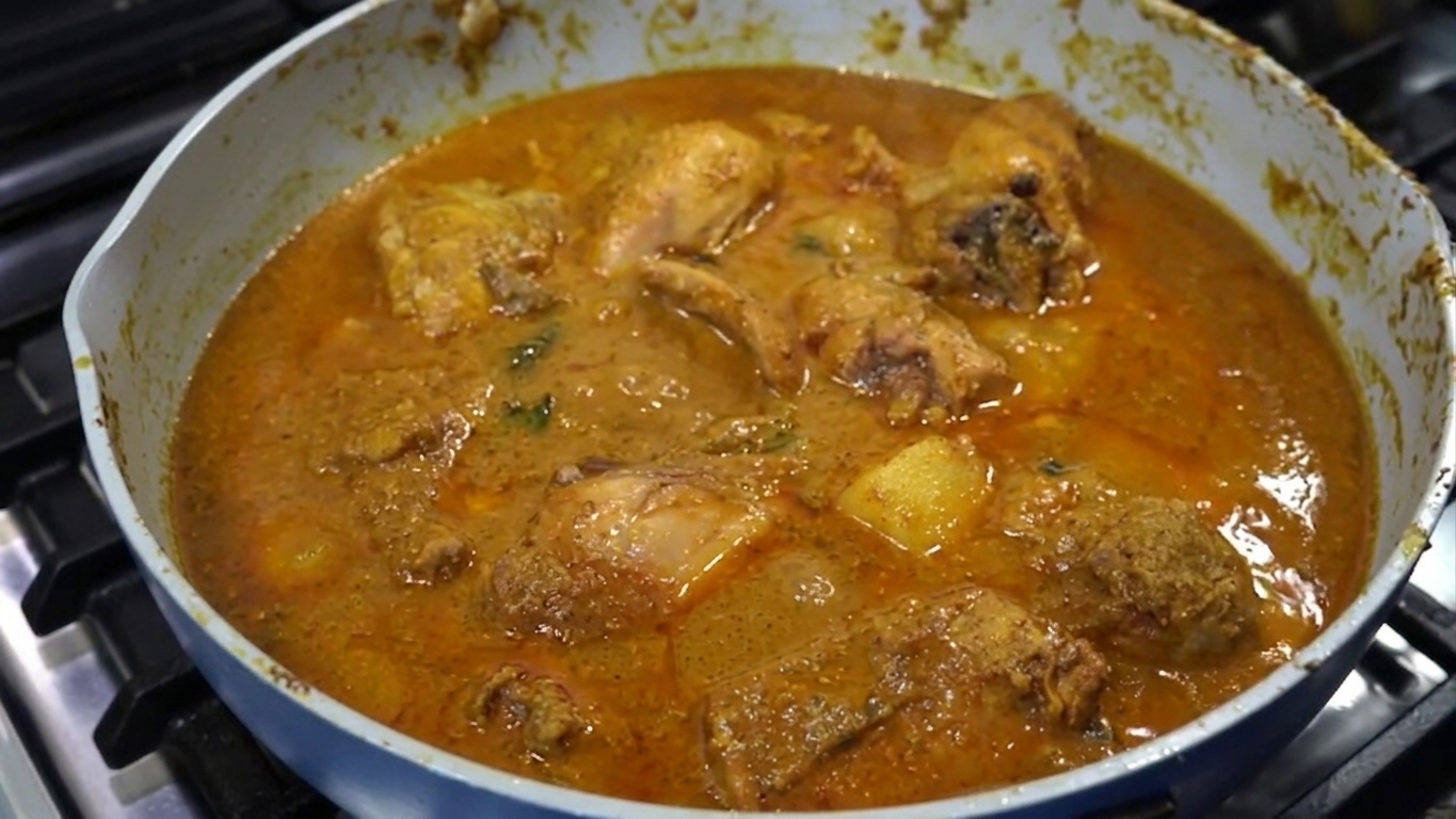 Freshly chopped coriander leaves and slit green chilies added to the chicken Xacuti curry