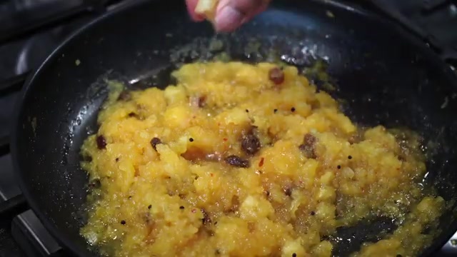 Fresh lemon juice being added to freshly cooked pineapple chutney