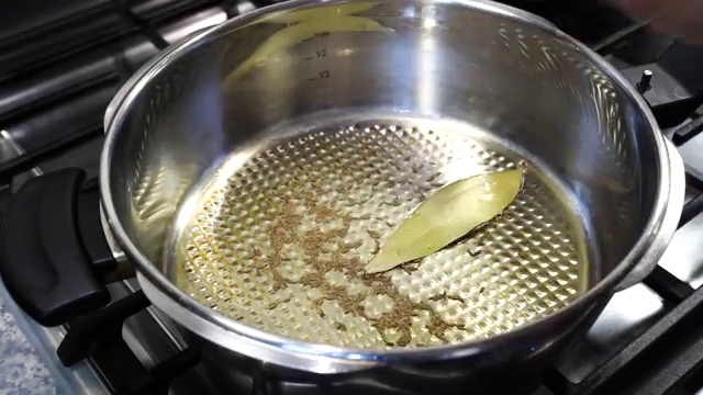Freshly grated ginger stirred into golden brown caramelized onions in the pot