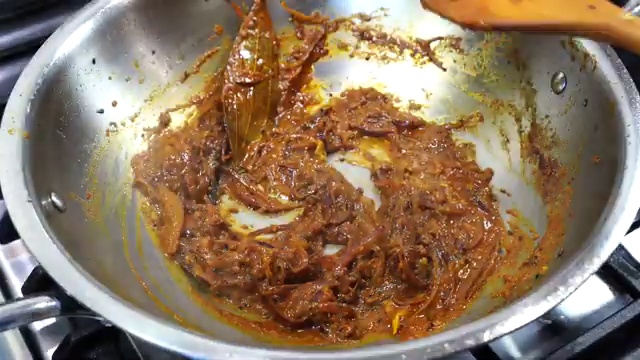Fried potatoes simmering gently in the onion and spiced curry masala