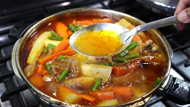 Green beans added to the finished hot chicken jhol to retain their bright color and snap