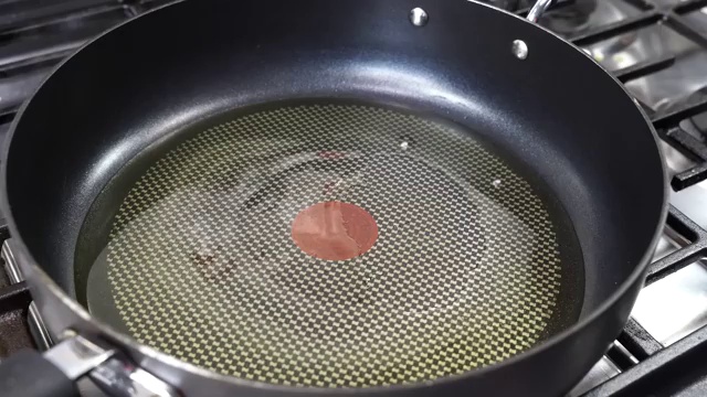 Chopped garlic slowly frying in oil until golden brown around the edges