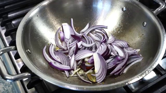 Ginger-garlic spice paste added to the softened onions in the skillet