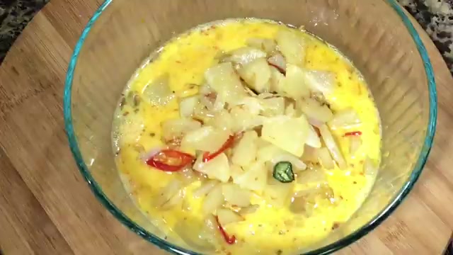 Golden brown tender potato slices and onions frying in the pan