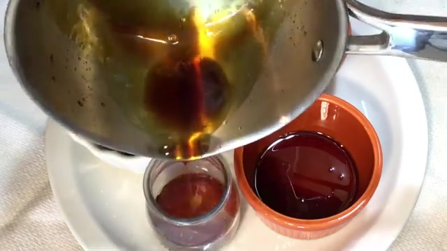 Golden caramel being poured into buttered pudding molds