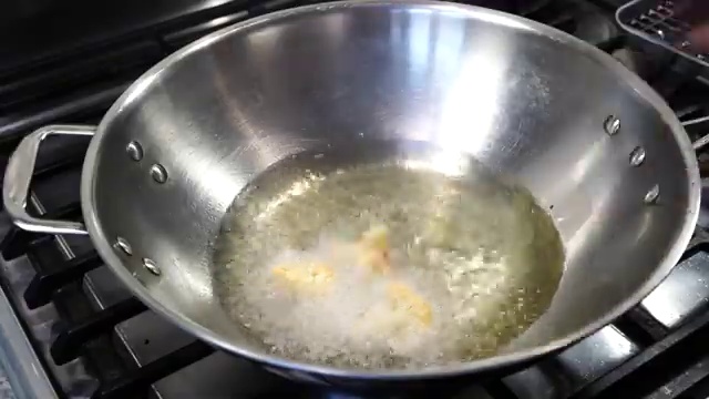Golden crispy fried cauliflower Manchurian florets resting and draining on paper towels