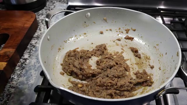 Golden fried fish fillets placed carefully into the bubbling curry gravy