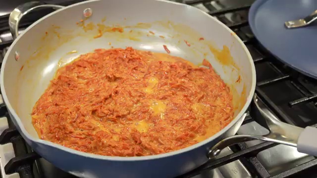 Crisp golden toasted flaked almonds set aside for garnishing carrot halwa
