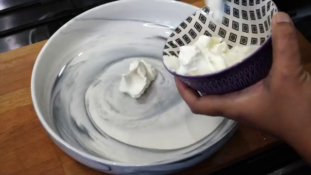Gram flour (besan) being added to the yogurt tandoori marinade as a binding agent