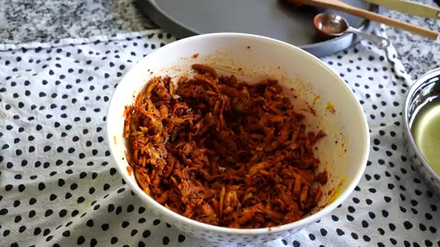 Grated green mango shreds thoroughly mixed with roasted spices, nigella seeds, and chili powder