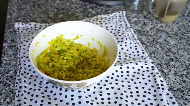 Coarsely ground pickle masala powder sprinkled over salted grated green mango