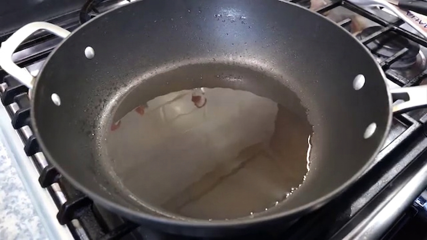 Cooking oil heating in a large wide non-stick pan over medium heat