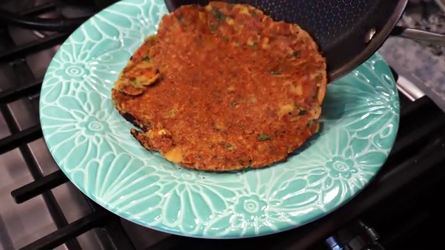 Mustard seeds and cumin seeds crackling in hot cooking oil in a small tempering pan