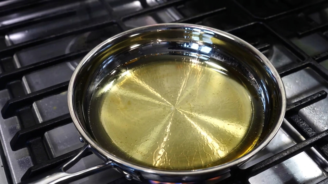 Aromatic hing (asafoetida) powder stirred into warm cooking oil in a pan