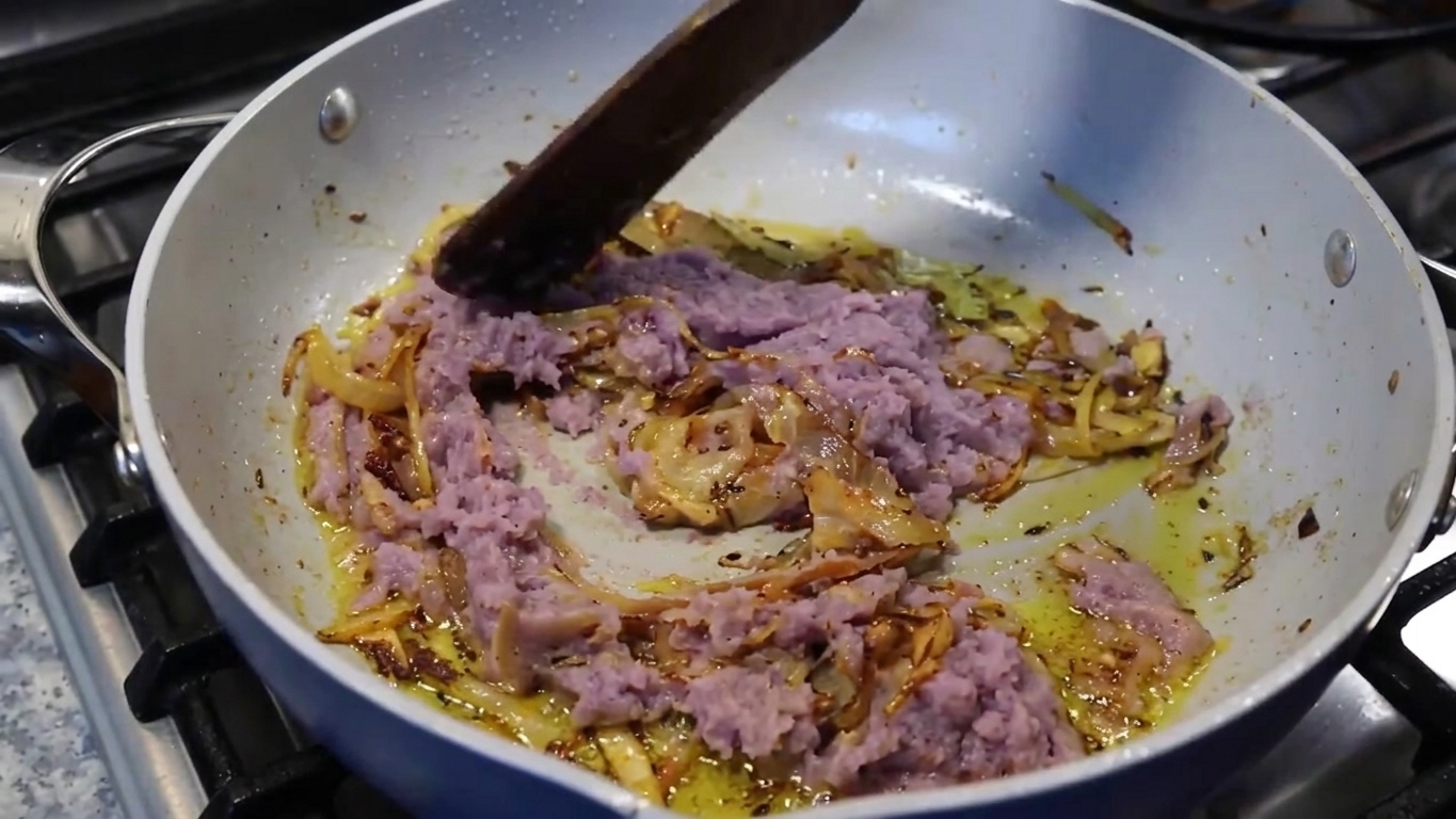 Hot water poured into the skillet to create the savory Bengali curry gravy