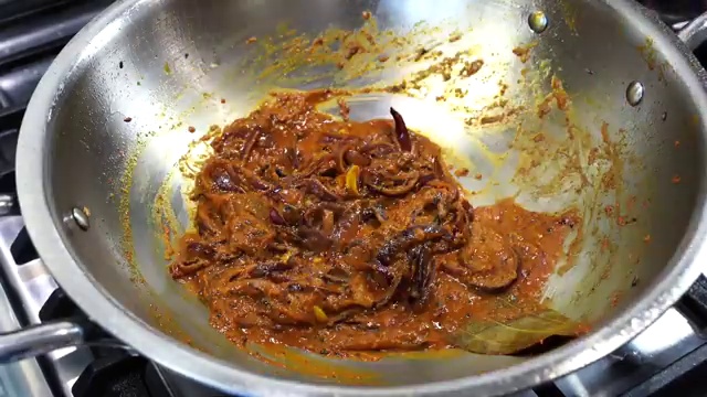 Hot water poured into the cooked Bengali masala to create a smooth base