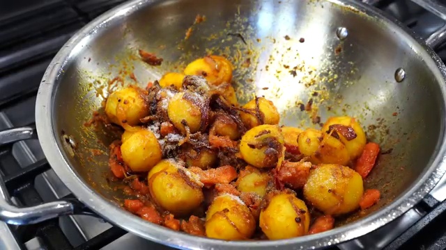 Hot water poured into the skillet to create the savory Aloo Dum curry gravy