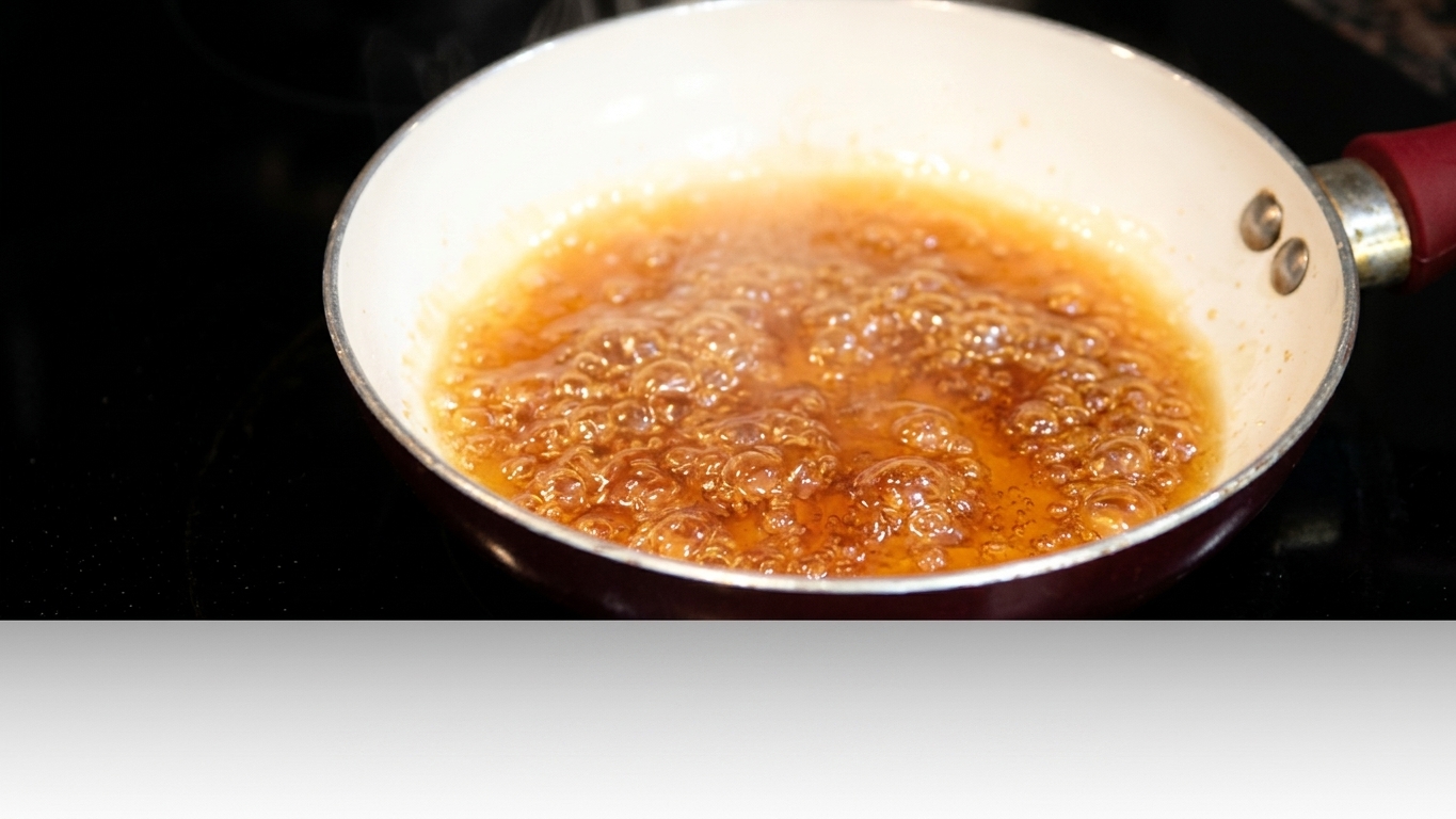 Hot water being carefully added to freshly prepared caramel