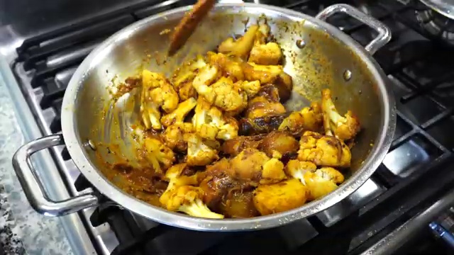 Hot water poured over the fried cauliflower and potatoes to form the savory gravy
