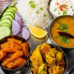 Indian Plant-Based Home-Cooked Meal - Steamed white rice served with moong masoor dal, cauliflower potato curry, and stir-fried pumpkin with nigella seeds