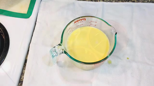 Individual pudding molds filled with smooth mango custard over caramel