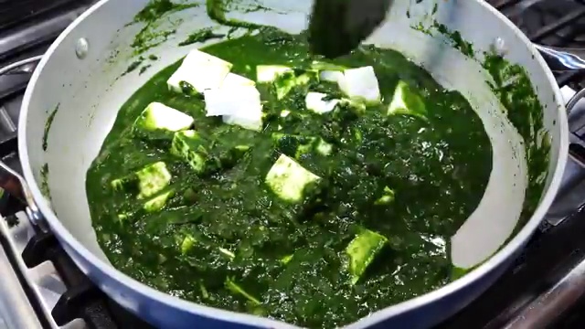 Crushed kasuri methi and garam masala powder added to the simmering spinach gravy