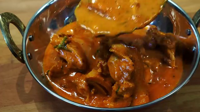 Large boneless skinless chicken thighs placed in a large mixing bowl for first marinade