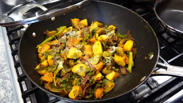 Turmeric-seasoned fish fillets lightly searing on both sides in the nigella seed oil