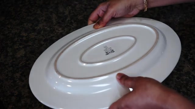 Mango caramel custard being inverted onto a large serving plate
