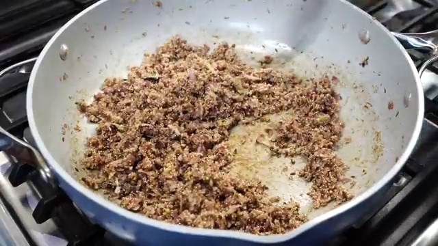 Marinated bone-in chicken pieces added to the skillet with the sizzled ginger and garlic