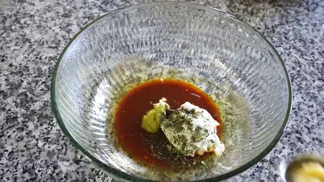 Marinated chicken pieces arranged in a single layer on wire rack and brushed with melted butter