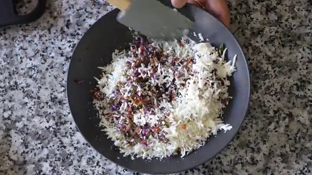 A ladle of yellow moong dal batter poured directly into the center of a hot greased tawa