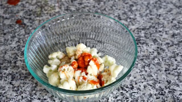 Cooking oil heating in a wok for deep-frying the battered cauliflower florets